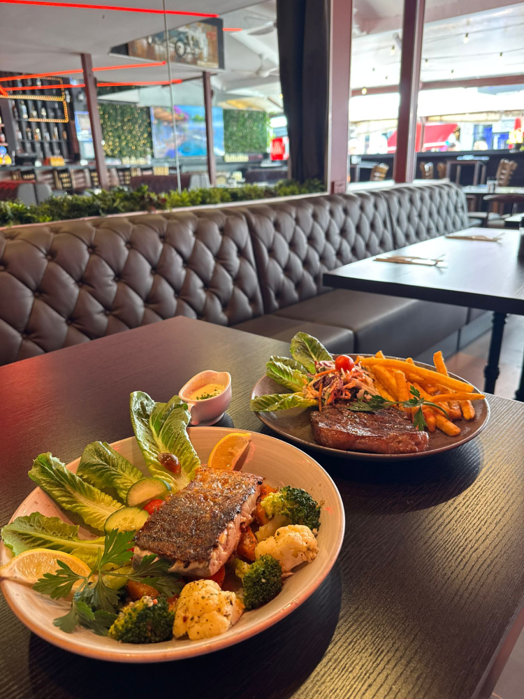 Steak and salmon dishes inside Central Lounge